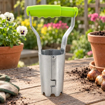 Stainless steel bulb planter in a garden bed with flower bulbs